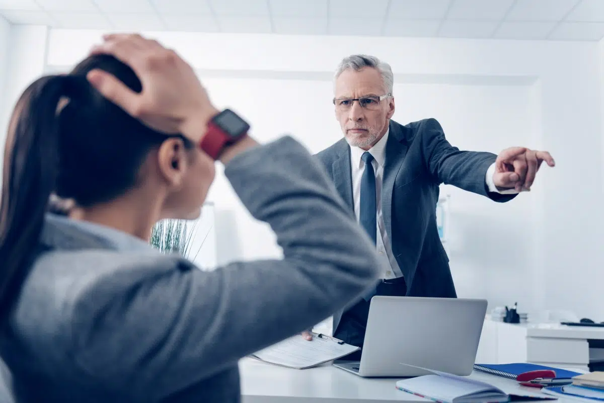 Angry boss gesturing for an employee to leave