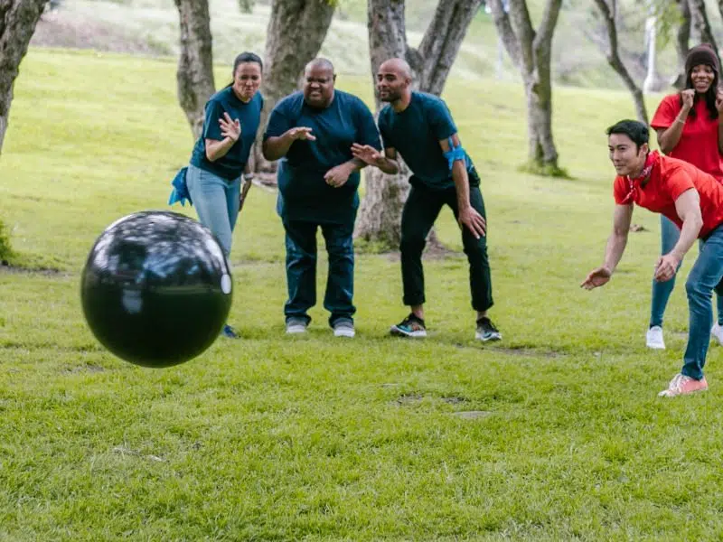 Group of adults playing a lawn bowling game