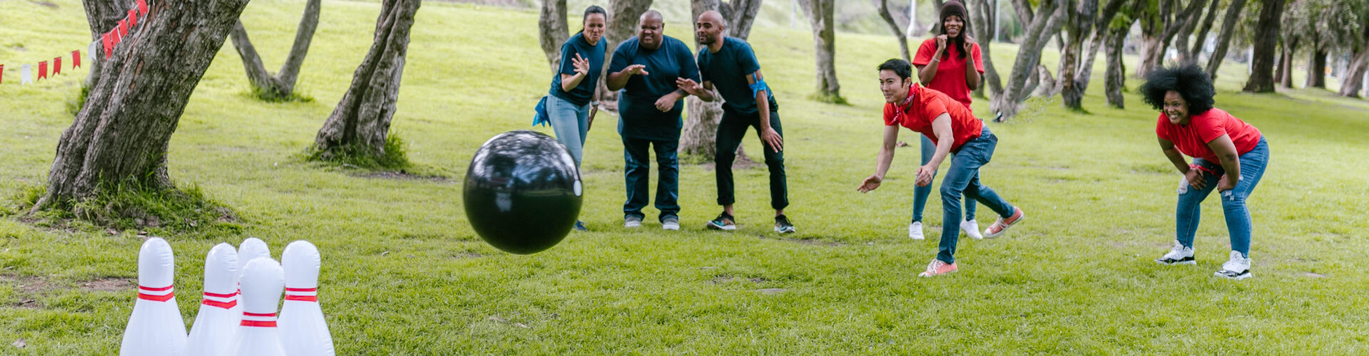 Group of adults playing a lawn bowling game