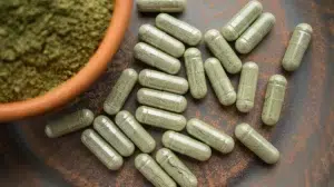 A few Kratom extract capsules and powder.