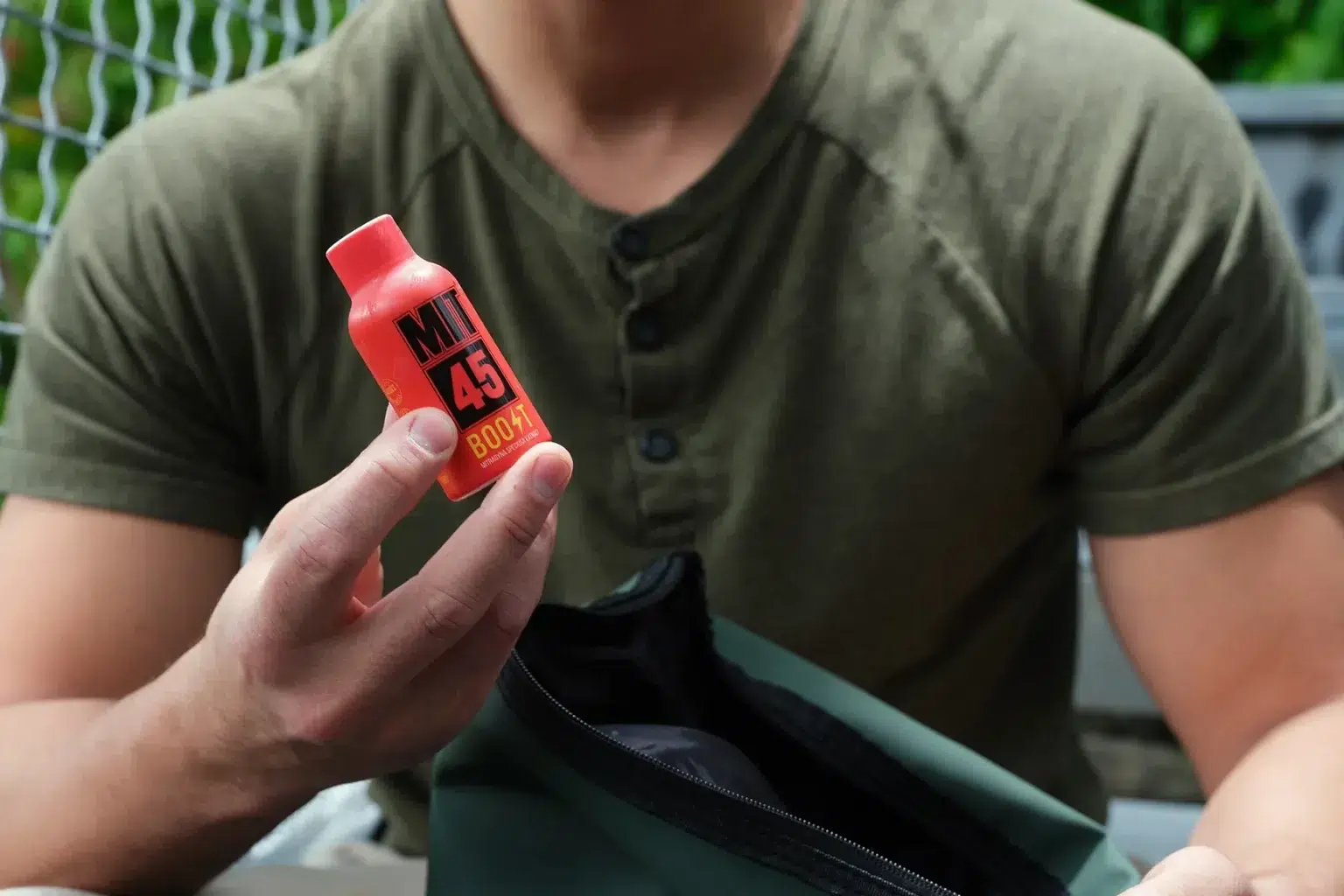 Man packing Boost shot into bag