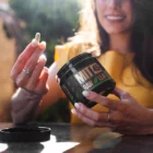 Woman holding a kratom capsule in the sun