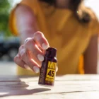 Woman holding MIT45 Super K Extra Strong on picnic table